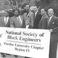Men from the National Society of Black Engineers holding a sign