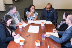 Singh executives working at table together