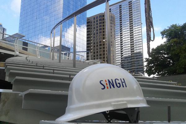 Singh hardhat in front of city view with skyscrapers